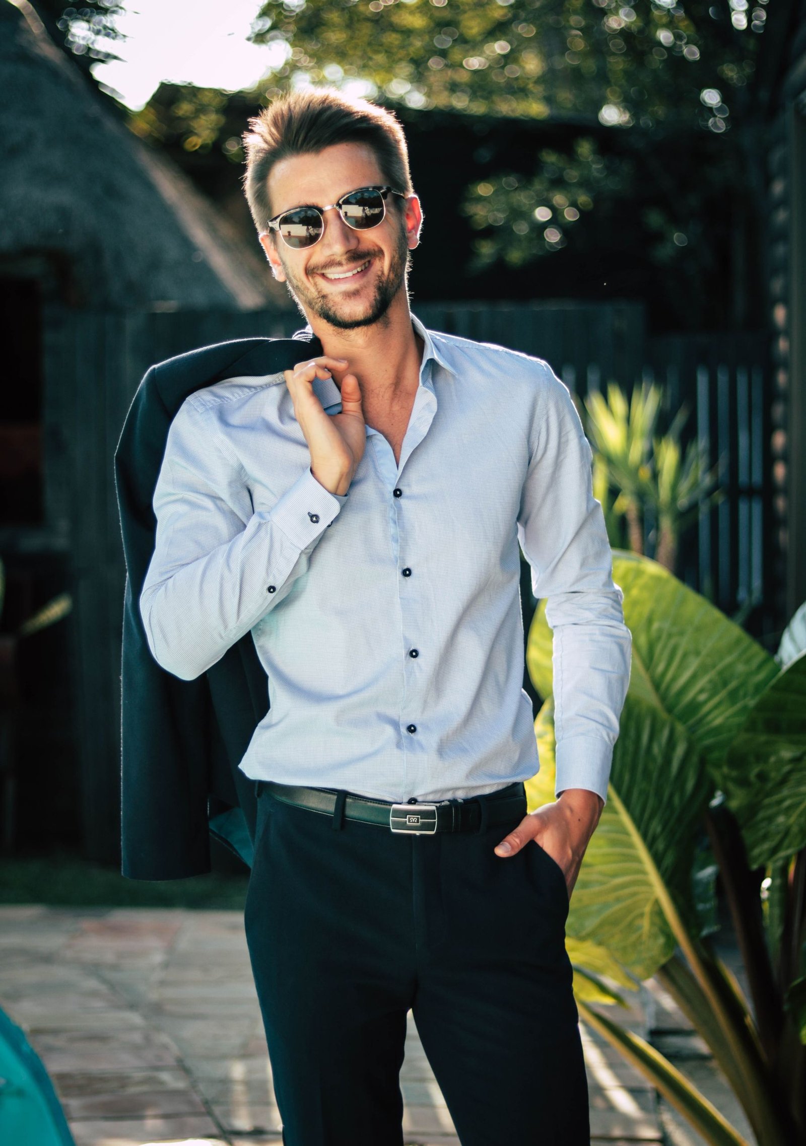 Model wearing a pale blue shirt outdoors